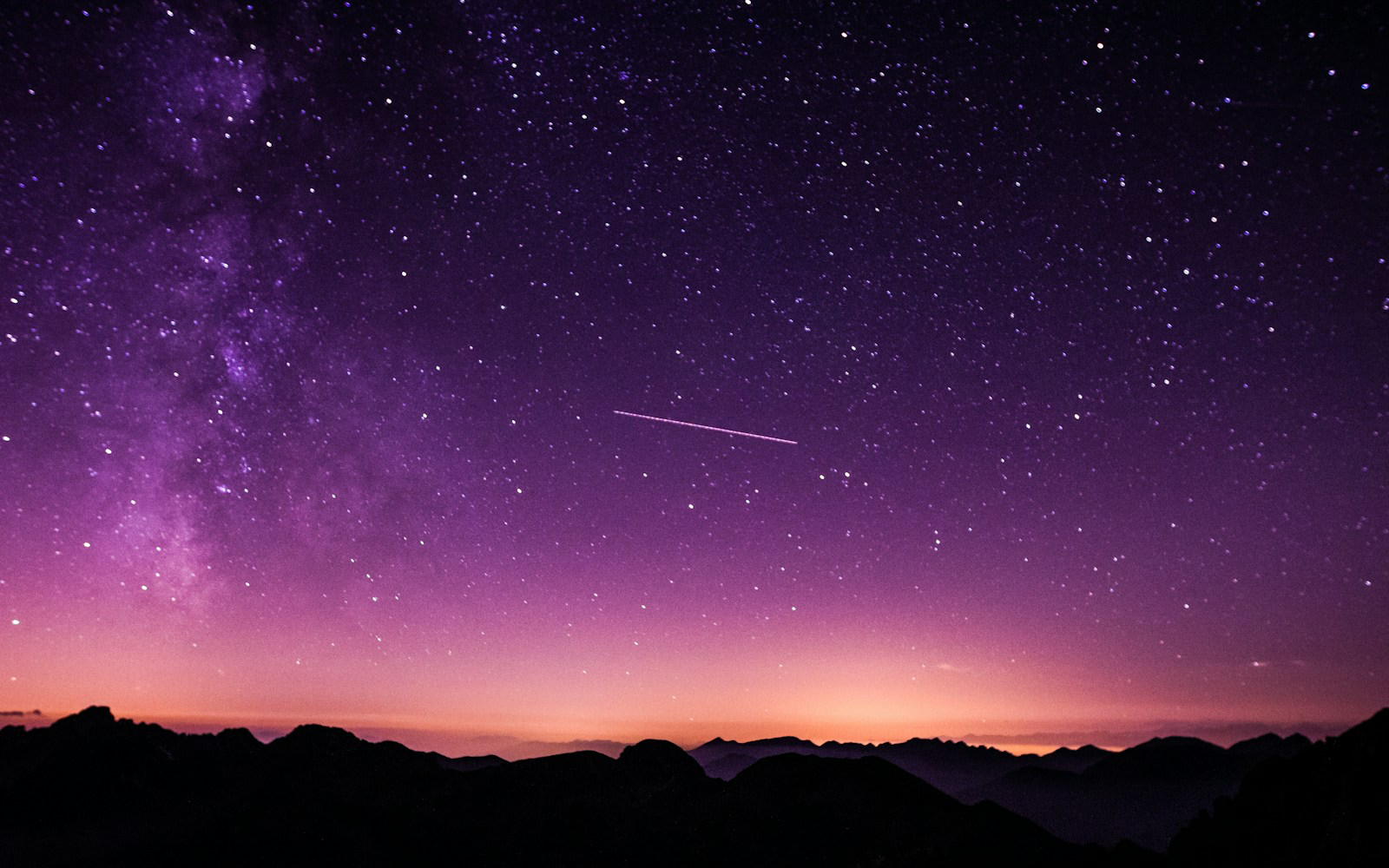A wide starry sky over a quiet landscape