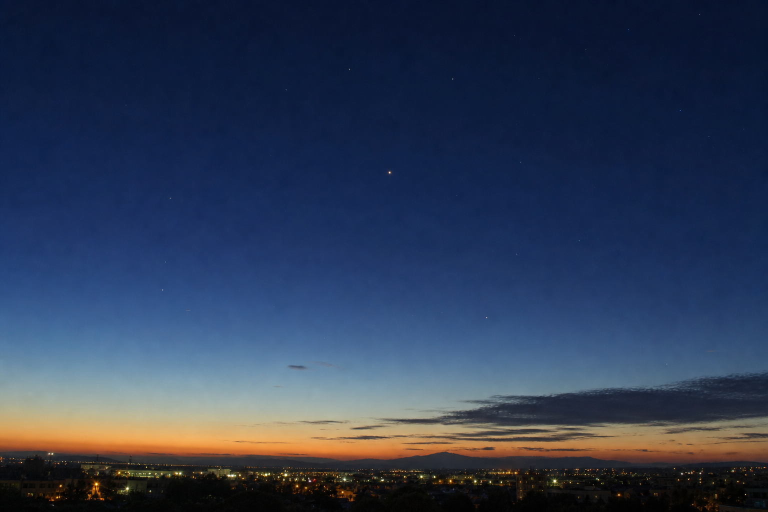 Beginner skywatcher on a balcony before dawn with the Last Quarter Moon and Saturn visible in the sky