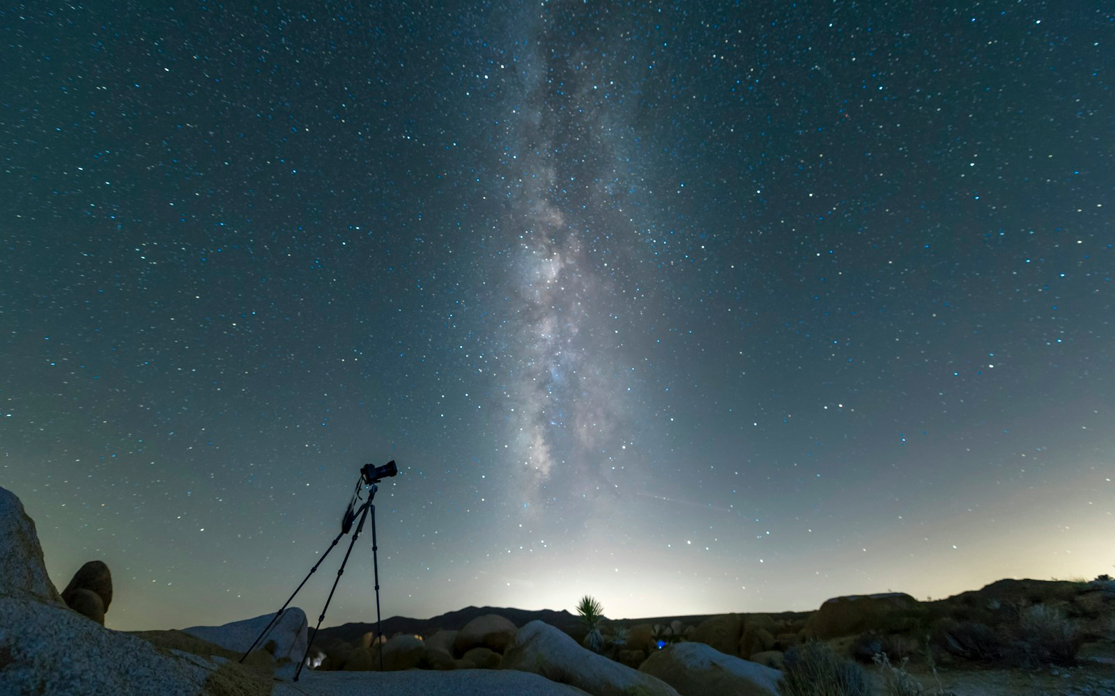 Four friends prepare cameras beneath a Hill Country sky