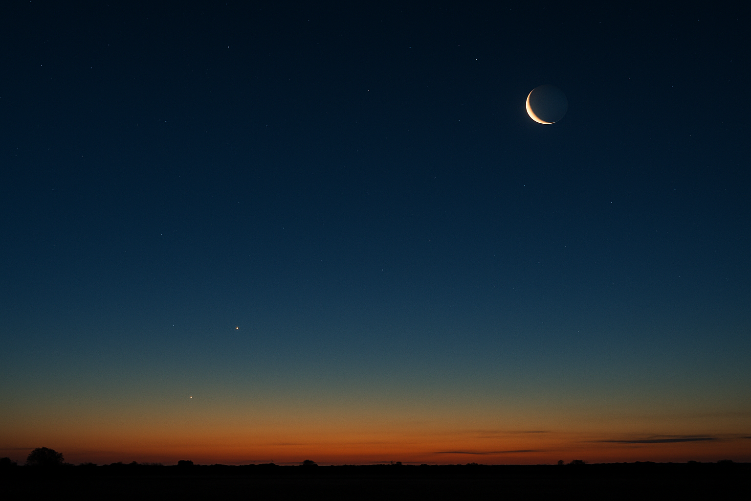 Predawn crescent Moon above a low eastern skyline