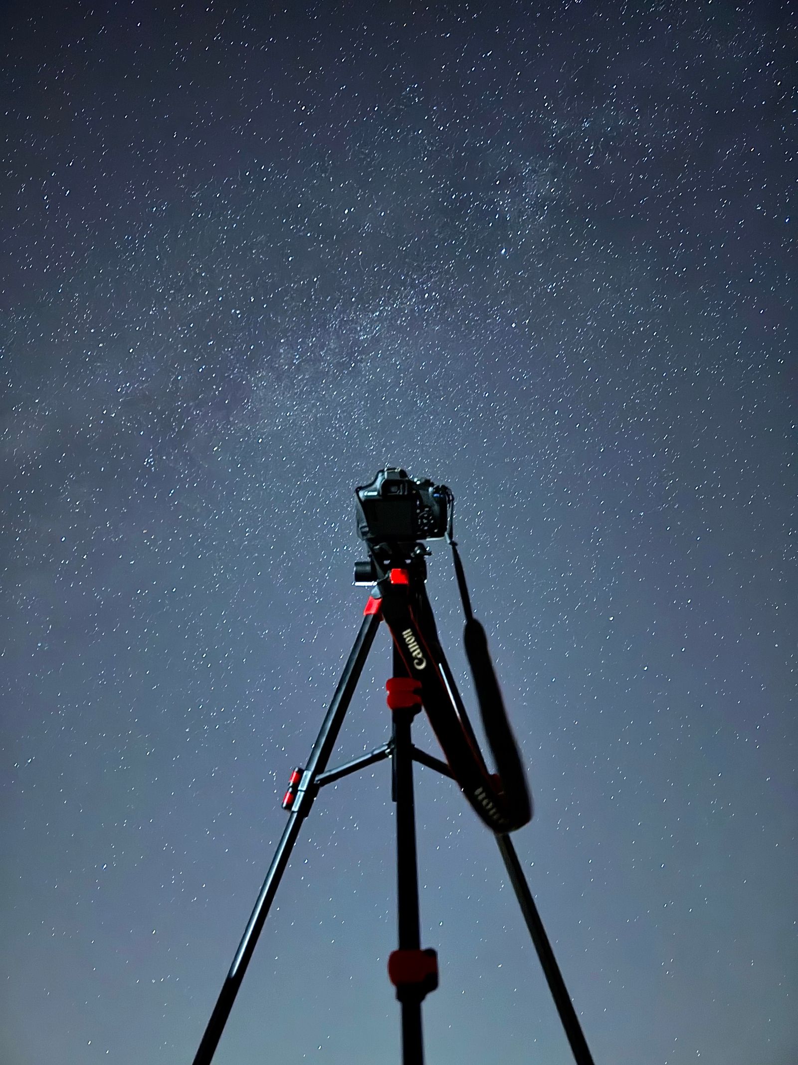 An astrophotography rig set up under a star-filled sky