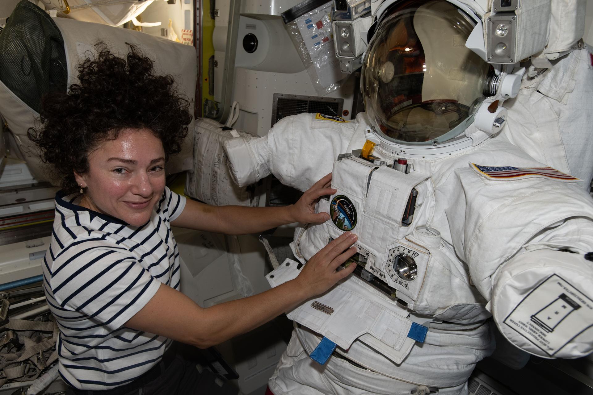 Astronaut working outside the International Space Station during a spacewalk above Earth