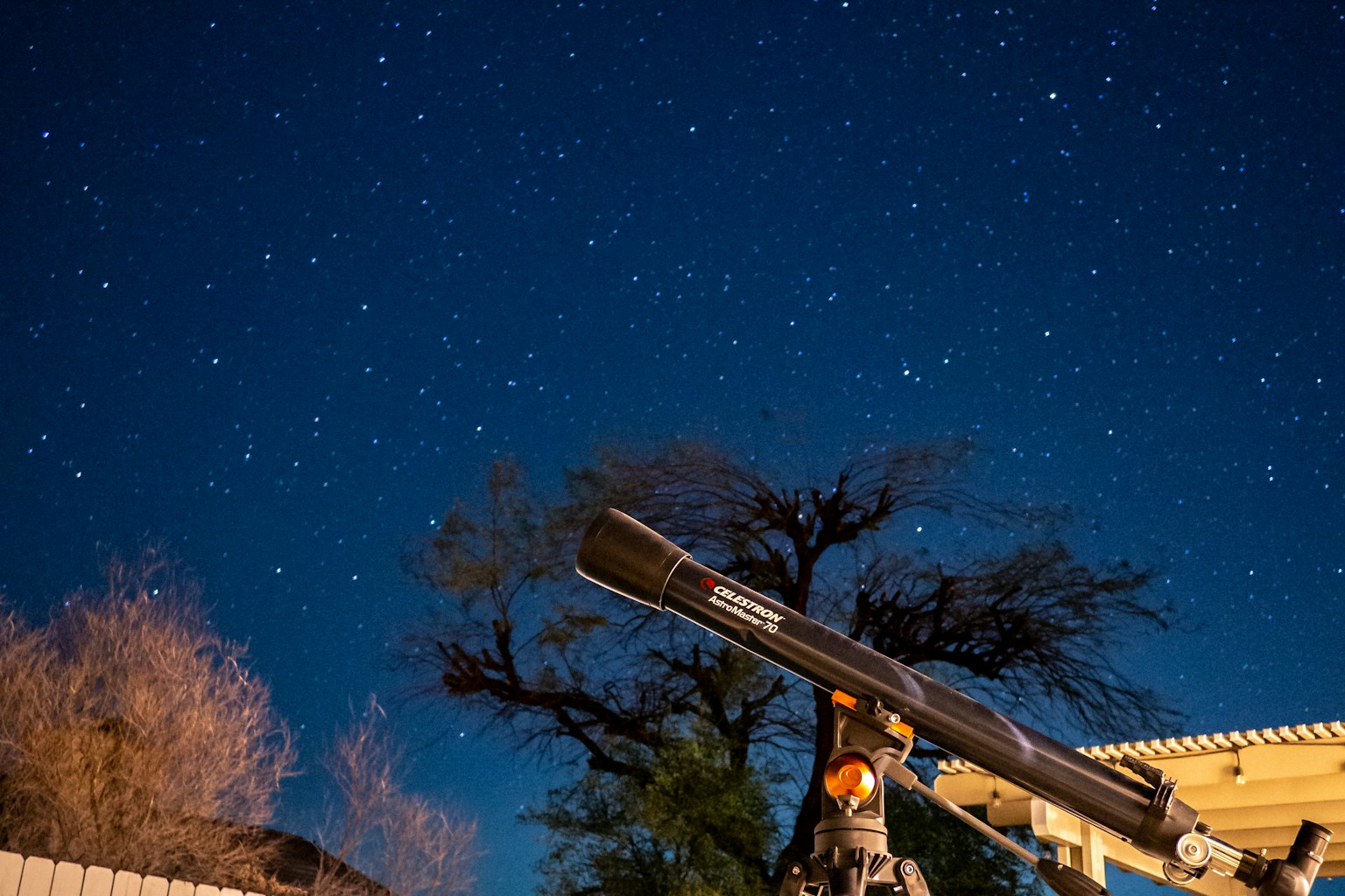Telescope beneath a starry night sky