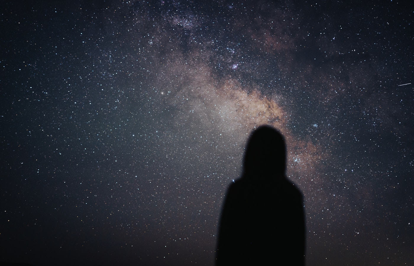 A person looking up at a star-filled sky