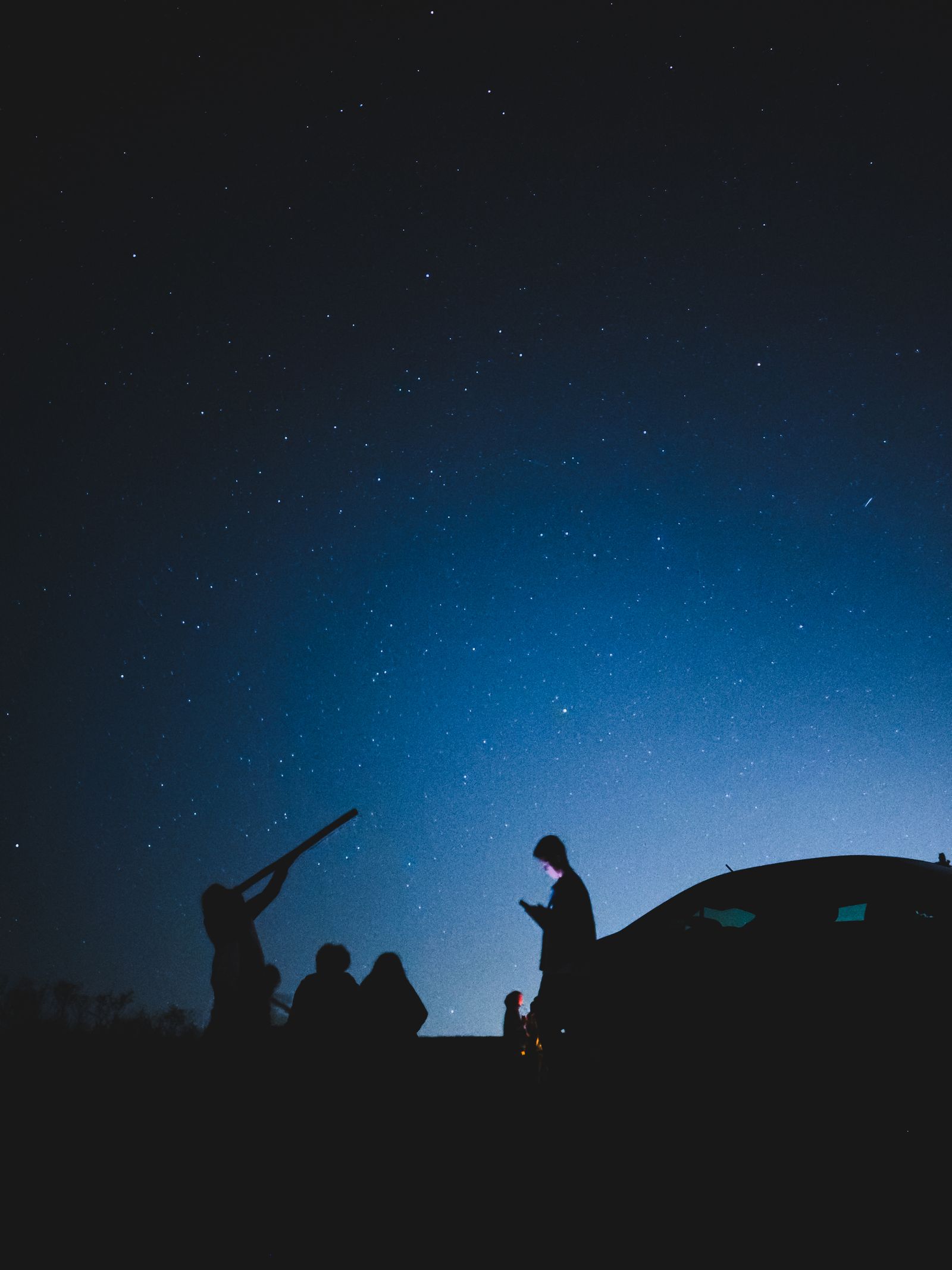 A small group shares a peaceful night of stargazing