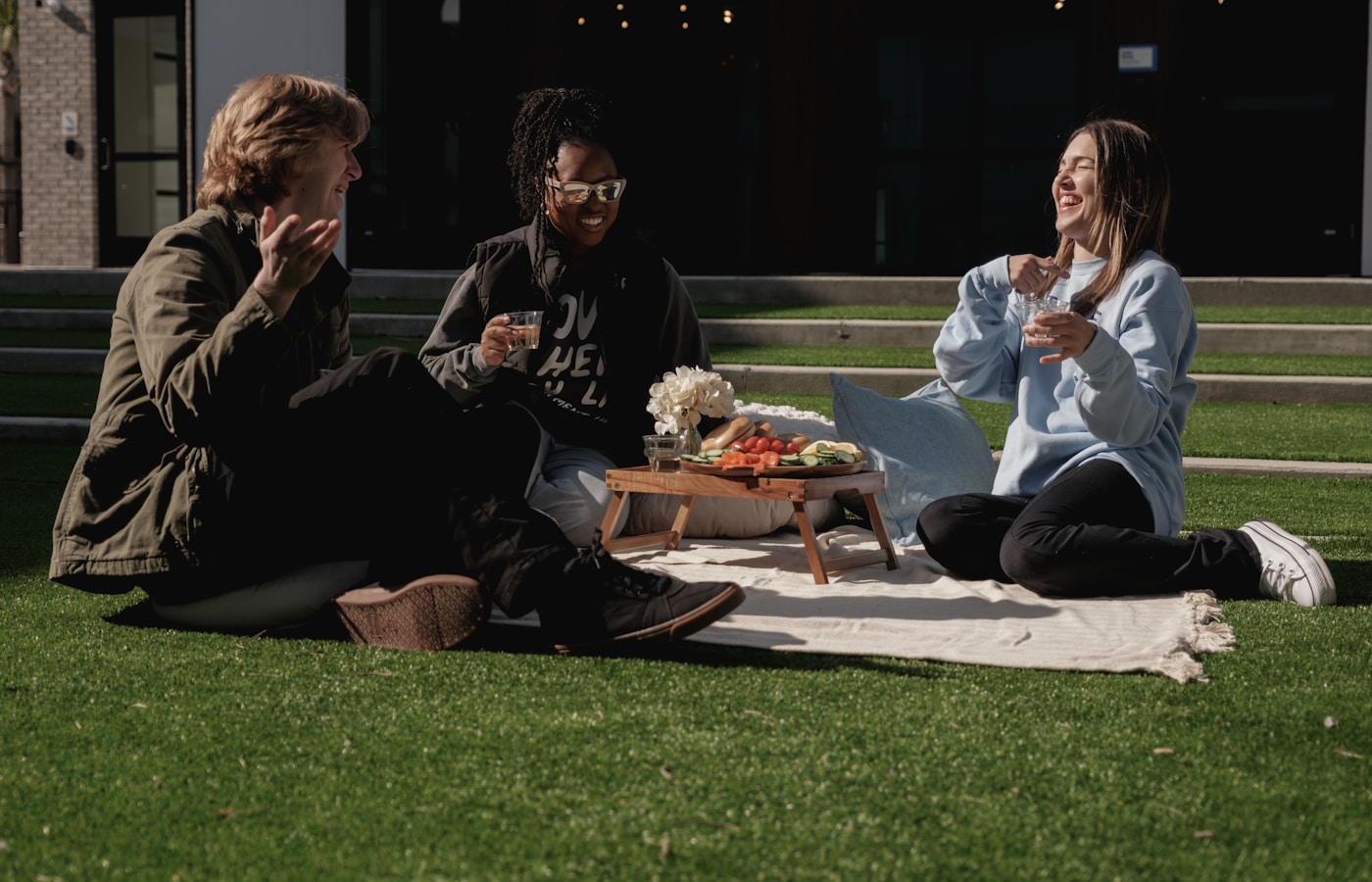 Friends sharing a picnic before stargazing