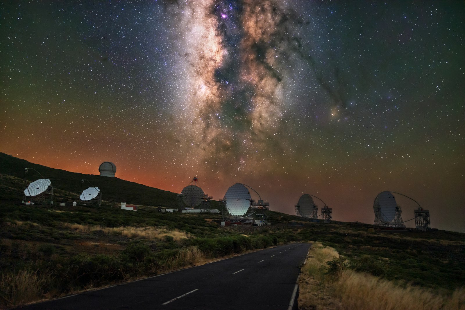 Observatory domes beneath the Milky Way at night