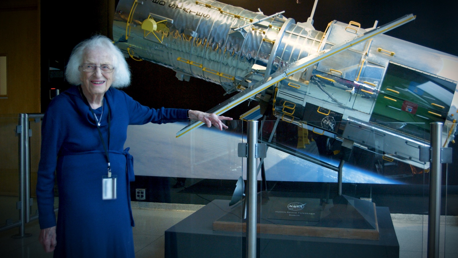 Nancy Grace Roman beside a scale model of the Hubble Space Telescope