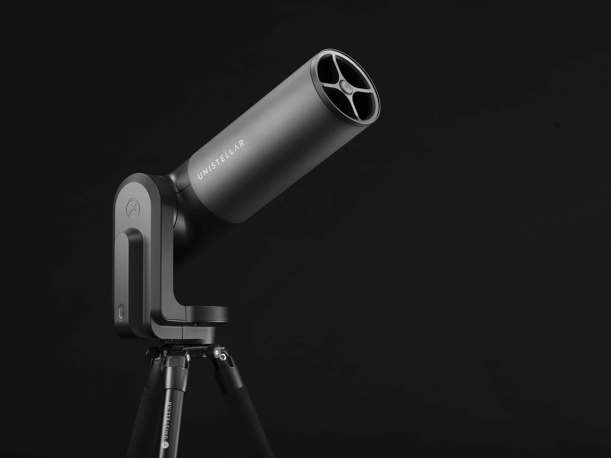 Unistellar EQUINOX 2 smart telescope on a tripod against a dark studio background