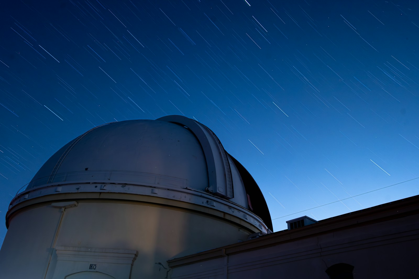 Observatory dome under a starry night sky above a mountain ridge, evoking a Mount Wilson public star party evening