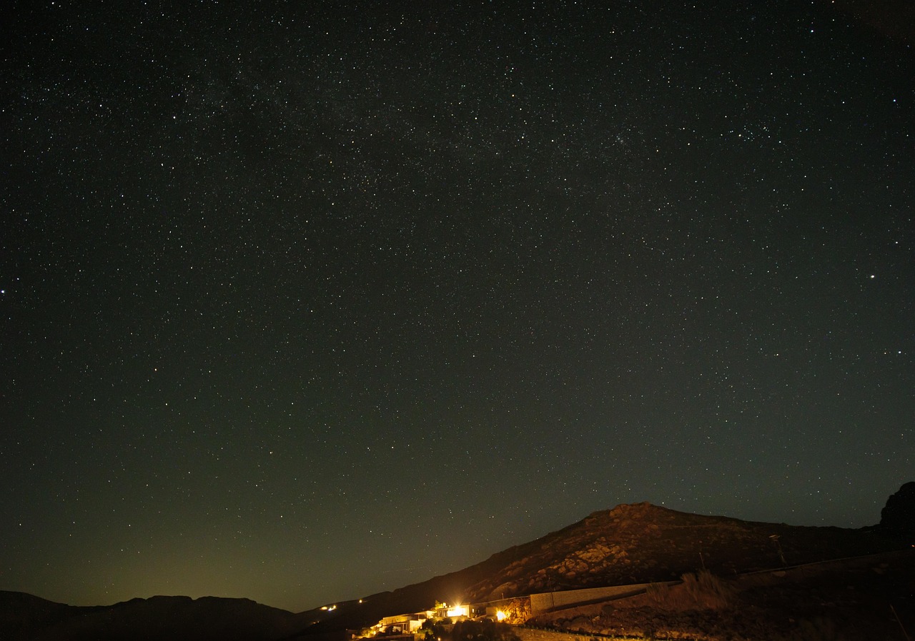 Mountain ridge beneath a dark star-filled sky